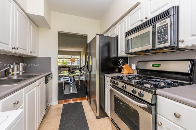 350 S Shore Dr Unit 7, Miami Beach, FL 33141 - kitchen with stainless steel appliances, white cabinets, and a sink