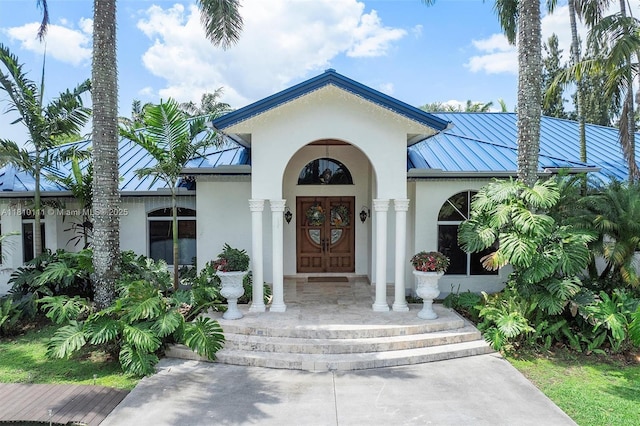 15960 SW 250th St, Homestead, FL 33031 - view of exterior entry featuring a standing seam roof, stucco siding, and metal roof