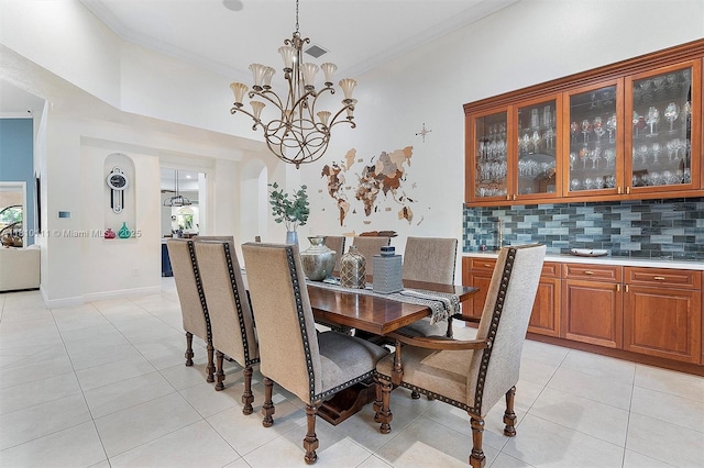15960 SW 250th St, Homestead, FL 33031 - dining room featuring light tile patterned floors, crown molding, a chandelier, and arched walkways