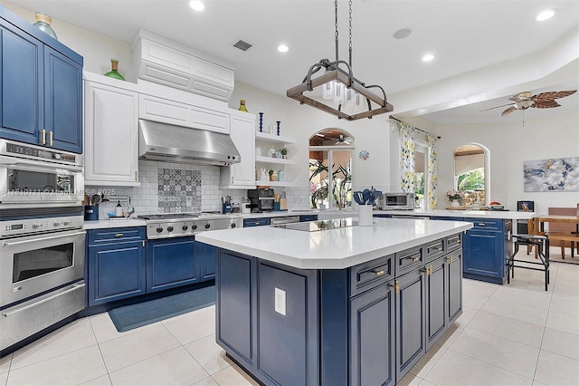 15960 SW 250th St, Homestead, FL 33031 - kitchen featuring blue cabinets, under cabinet range hood, a warming drawer, light countertops, and recessed lighting