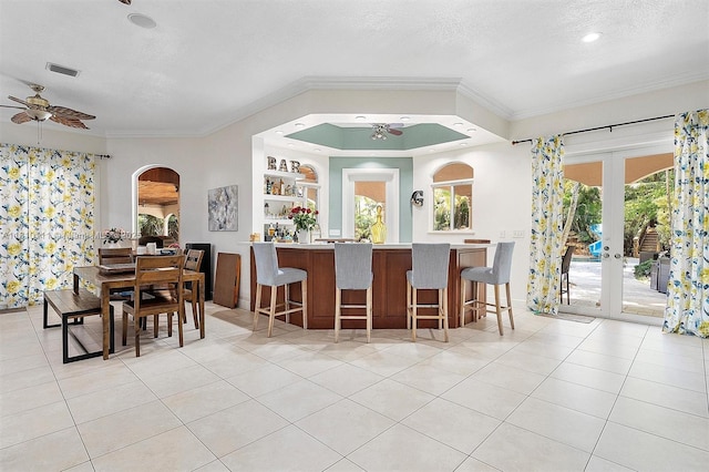 15960 SW 250th St, Homestead, FL 33031 - dining room featuring ceiling fan, light tile patterned floors, ornamental molding, arched walkways, and french doors