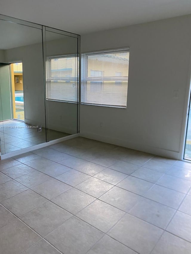 1975 NE 135th St Unit 2D, North Miami, FL 33181 - empty room with light tile patterned floors