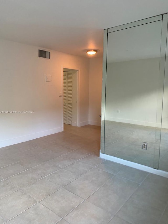 1975 NE 135th St Unit 2D, North Miami, FL 33181 - empty room featuring light tile patterned floors and baseboards