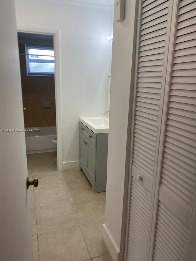 1975 NE 135th St Unit 2D, North Miami, FL 33181 - bathroom with a closet, vanity, tile patterned floors, and baseboards