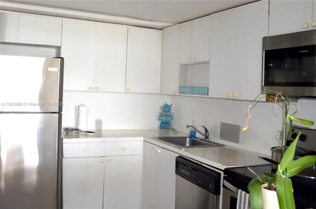 13499 Biscayne Blvd Unit 702, North Miami, FL 33181 - kitchen featuring stainless steel appliances, a sink, white cabinets, and light countertops