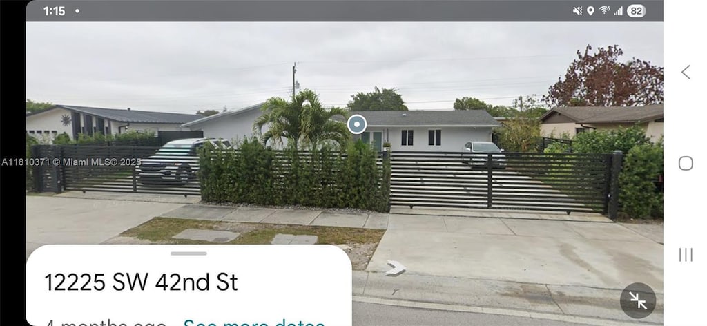 12225 SW 42nd St, Miami, FL 33175 - view of front of house featuring a fenced front yard, a gate, and concrete driveway
