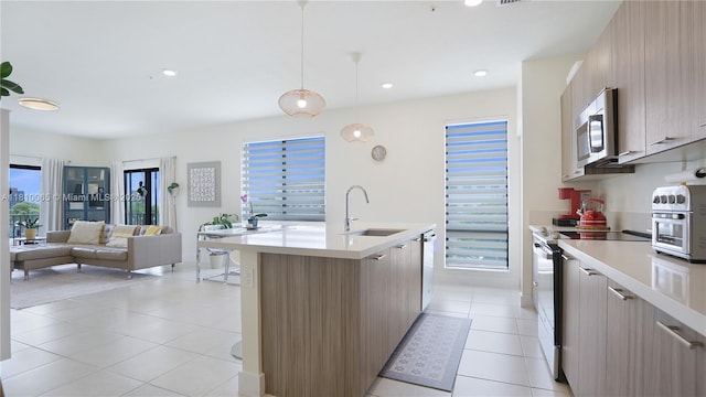 8301 NW 41st St Unit B-404, Doral, FL 33166 - kitchen featuring range with electric cooktop, stainless steel microwave, modern cabinets, a sink, and recessed lighting