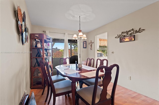 1090 NW 66th Ter, Margate, FL 33063 - dining space with a chandelier, light wood-style floors, and baseboards