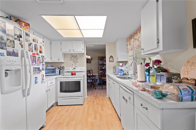 1090 NW 66th Ter, Margate, FL 33063 - kitchen featuring white appliances, a sink, light countertops, light wood-style floors, and white cabinetry