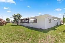 1090 NW 66th Ter, Margate, FL 33063 - view of side of home with a yard