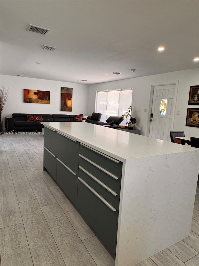 501 SW 18th St, Pompano Beach, FL 33060 - kitchen with a center island, open floor plan, recessed lighting, modern cabinets, and light wood finished floors