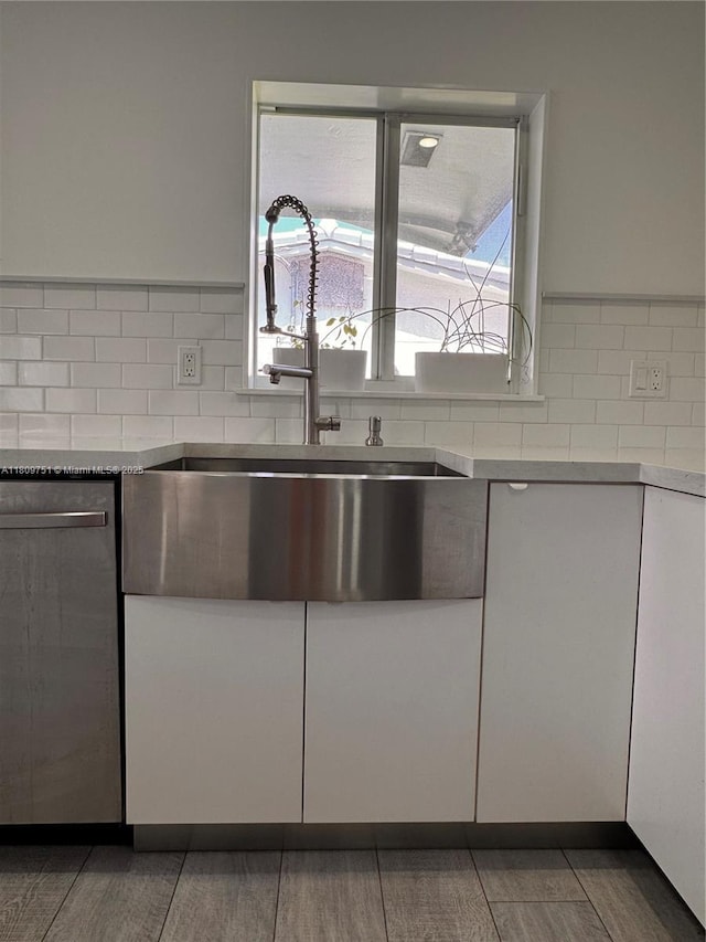 501 SW 18th St, Pompano Beach, FL 33060 - kitchen featuring dishwasher, a sink, white cabinetry, and decorative backsplash