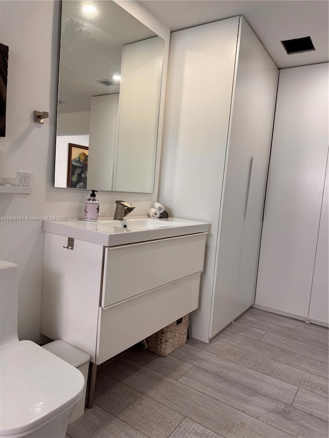 501 SW 18th St, Pompano Beach, FL 33060 - bathroom with vanity, wood finished floors, and toilet