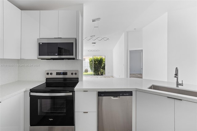 7572 NW 3rd St, Plantation, FL 33317 - kitchen featuring stainless steel appliances, modern cabinets, a sink, white cabinets, and light countertops