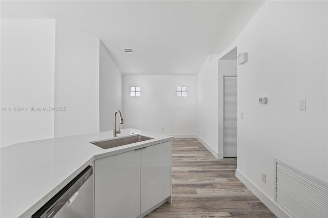 7572 NW 3rd St, Plantation, FL 33317 - kitchen with a sink, stainless steel dishwasher, white cabinets, light wood-style floors, and light countertops