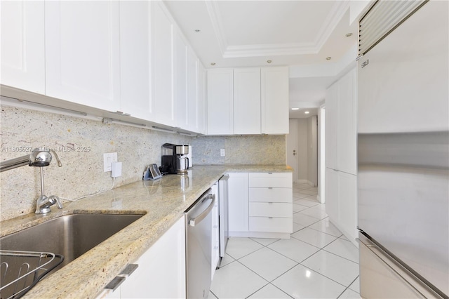 881 Ocean Dr Unit 13H, Key Biscayne, FL 33149 - kitchen with appliances with stainless steel finishes, light tile patterned flooring, tasteful backsplash, white cabinets, and a raised ceiling