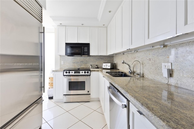 881 Ocean Dr Unit 13H, Key Biscayne, FL 33149 - kitchen featuring stainless steel appliances, light stone counters, white cabinetry, light tile patterned flooring, and decorative backsplash