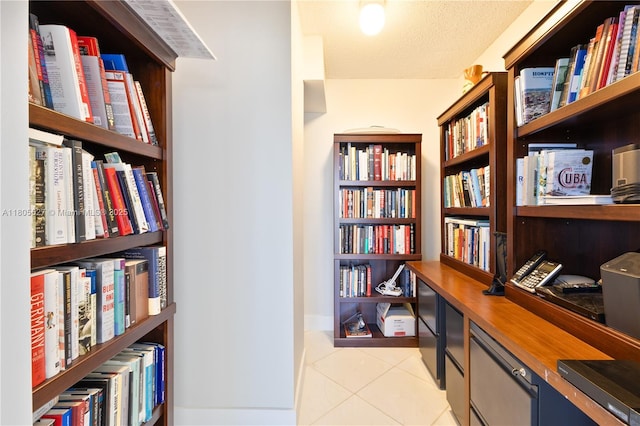 881 Ocean Dr Unit 13H, Key Biscayne, FL 33149 - office featuring wall of books, light tile patterned flooring, and a textured ceiling