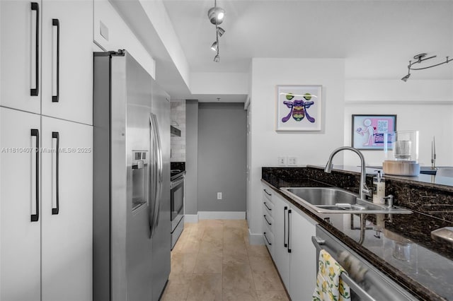 3232 SW 22nd Ter Unit 1106, Miami, FL 33145 - kitchen with appliances with stainless steel finishes, a sink, white cabinetry, dark stone countertops, and baseboards
