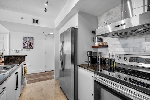 3232 SW 22nd Ter Unit 1106, Miami, FL 33145 - kitchen featuring stainless steel appliances, wall chimney exhaust hood, white cabinets, and tasteful backsplash
