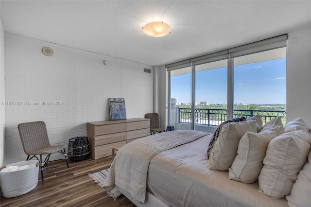 3232 SW 22nd Ter Unit 1106, Miami, FL 33145 - bedroom with wood finished floors, access to exterior, and brick wall