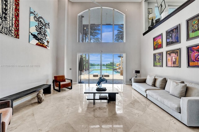 11356 Canyon Maple Blvd, Davie, FL 33330 - living area featuring marble tiled floors, a towering ceiling, a water view, and baseboards