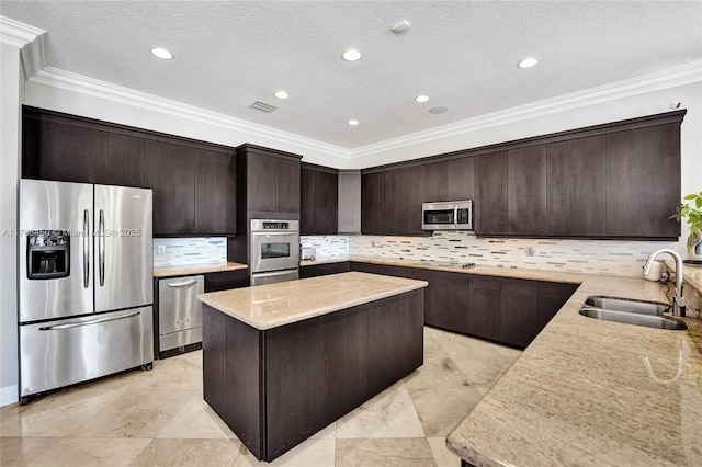 11356 Canyon Maple Blvd, Davie, FL 33330 - kitchen featuring appliances with stainless steel finishes, a sink, a center island, dark brown cabinets, and a textured ceiling