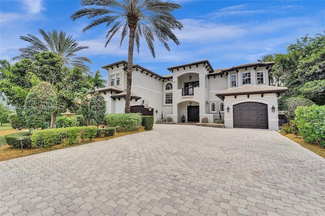 11356 Canyon Maple Blvd, Davie, FL 33330 - mediterranean / spanish-style home with decorative driveway, stucco siding, a balcony, and a garage