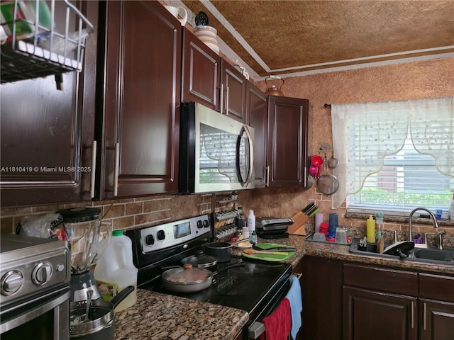 22374 SW 57th Cir, Boca Raton, FL 33428 - kitchen featuring stainless steel appliances, a sink, decorative backsplash, crown molding, and dark brown cabinetry