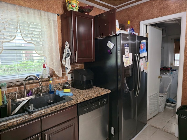 22374 SW 57th Cir, Boca Raton, FL 33428 - kitchen with stainless steel dishwasher, washing machine and clothes dryer, black refrigerator with ice dispenser, tasteful backsplash, and light tile patterned floors