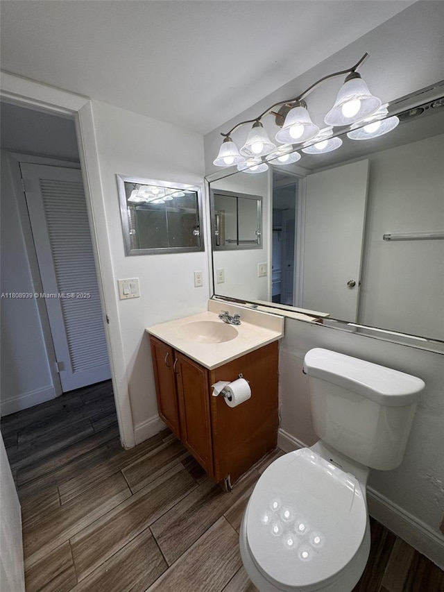 218 Windsor J Unit 218, West Palm Beach, FL 33417 - bathroom featuring vanity, toilet, and wood finished floors