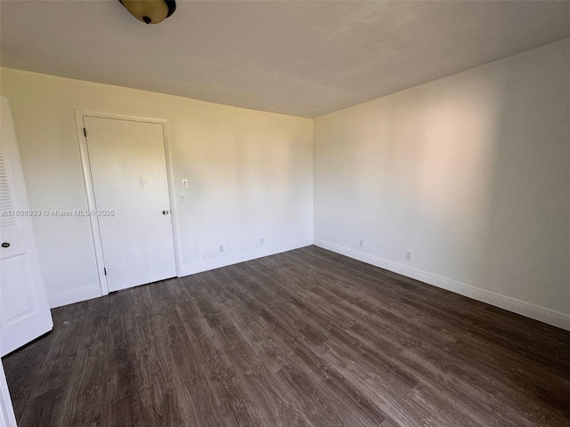 218 Windsor J Unit 218, West Palm Beach, FL 33417 - spare room with dark wood-style floors and baseboards