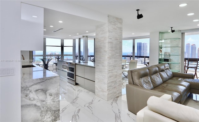 3500 Mystic Pointe Dr Unit 3906, Aventura, FL 33180 - living area featuring decorative columns, light marble finish floors, and recessed lighting