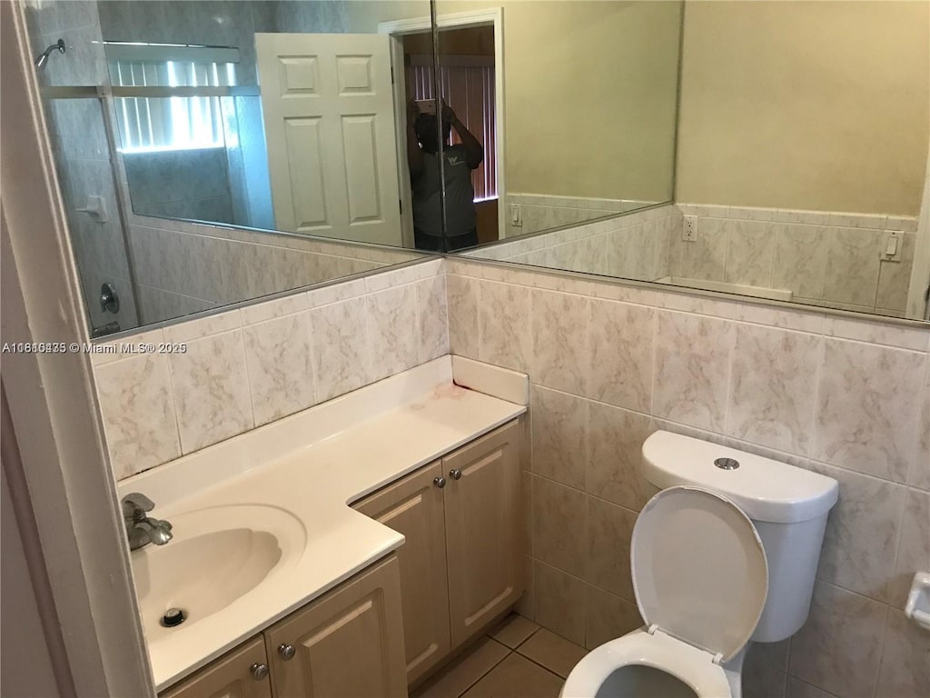 12912 NE 7th Ave, North Miami, FL 33161 - full bathroom with vanity, tile walls, a shower, and tile patterned flooring