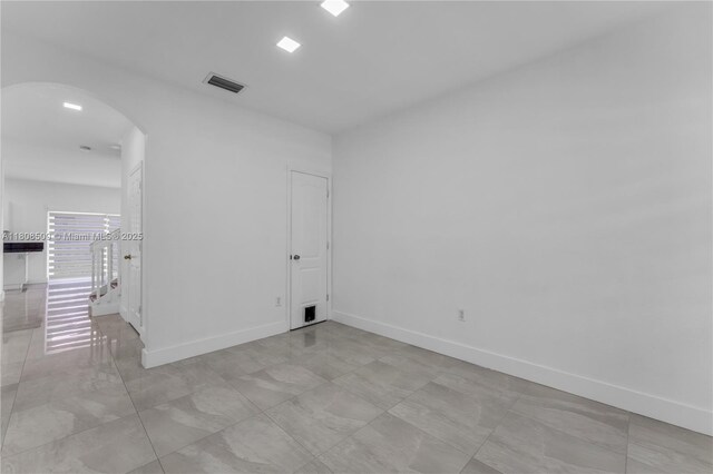 9285 SW 220th Ter, Cutler Bay, FL 33190 - spare room featuring arched walkways and baseboards