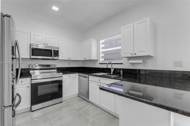 9285 SW 220th Ter, Cutler Bay, FL 33190 - kitchen featuring stainless steel appliances, white cabinets, and dark stone countertops