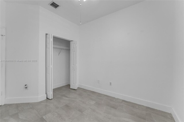 9285 SW 220th Ter, Cutler Bay, FL 33190 - unfurnished bedroom featuring baseboards and a closet