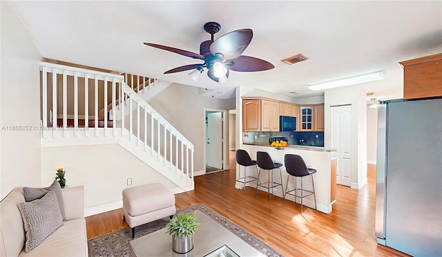15141 SW 46th St, Miramar, FL 33027 - living room featuring light wood-type flooring, ceiling fan, and stairway