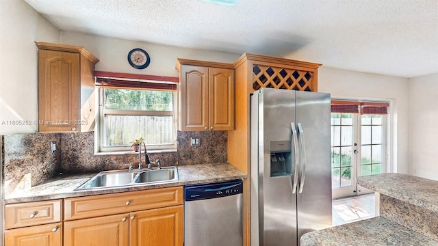 15141 SW 46th St, Miramar, FL 33027 - kitchen featuring appliances with stainless steel finishes, a textured ceiling, plenty of natural light, and backsplash