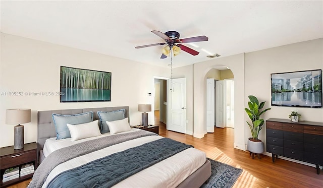 15141 SW 46th St, Miramar, FL 33027 - bedroom with arched walkways, wood finished floors, and ceiling fan