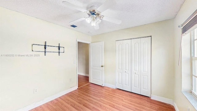 15141 SW 46th St, Miramar, FL 33027 - unfurnished bedroom featuring a textured ceiling, light wood-style floors, a closet, and ceiling fan