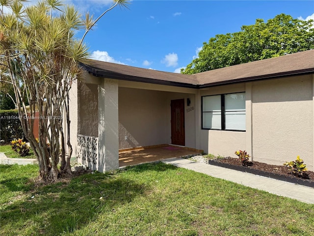 5506 SW 134th Pl, Miami, FL 33175 - property entrance with stucco siding and a lawn