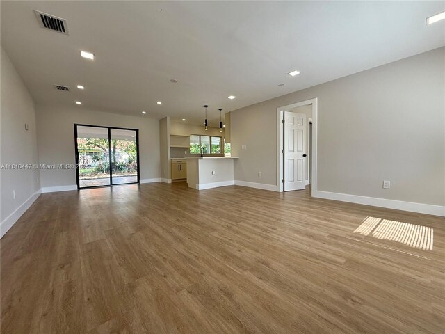 5506 SW 134th Pl, Miami, FL 33175 - unfurnished living room featuring baseboards, light wood finished floors, recessed lighting, and a sink