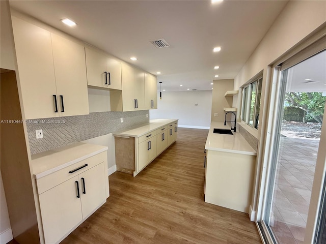 5506 SW 134th Pl, Miami, FL 33175 - kitchen with a sink, decorative backsplash, baseboards, light wood finished floors, and recessed lighting
