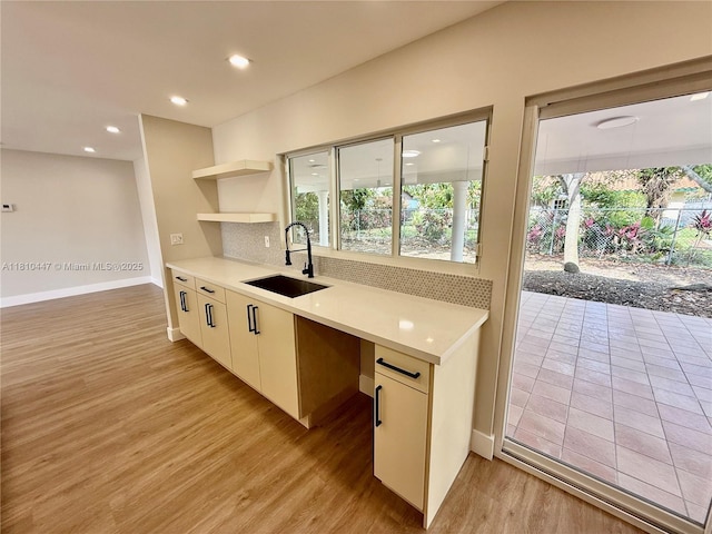 5506 SW 134th Pl, Miami, FL 33175 - kitchen with a sink, backsplash, light wood finished floors, light countertops, and baseboards