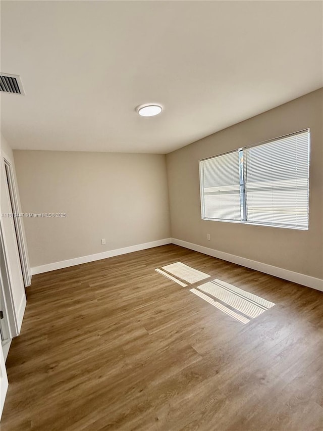 5506 SW 134th Pl, Miami, FL 33175 - spare room with baseboards and wood finished floors