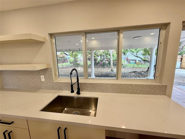 5506 SW 134th Pl, Miami, FL 33175 - kitchen featuring a sink, backsplash, light countertops, and open shelves