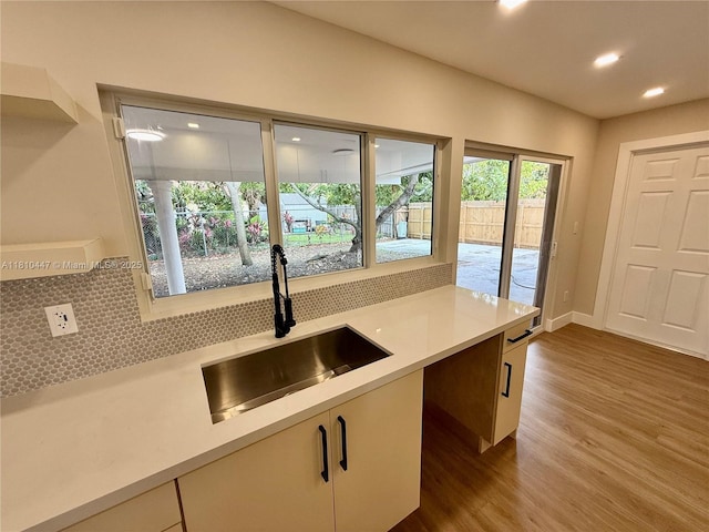 5506 SW 134th Pl, Miami, FL 33175 - kitchen featuring a sink, dark wood-style flooring, decorative backsplash, light countertops, and recessed lighting