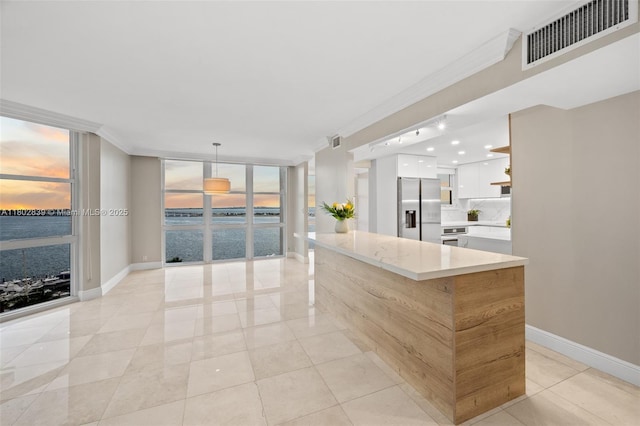 1901 Brickell Ave Unit B1114, Miami, FL 33129 - kitchen featuring stainless steel fridge with ice dispenser, floor to ceiling windows, crown molding, white cabinets, and open shelves