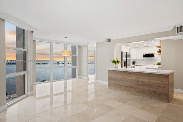 1901 Brickell Ave Unit B1114, Miami, FL 33129 - kitchen featuring stainless steel appliances, modern cabinets, white cabinetry, light countertops, and floor to ceiling windows